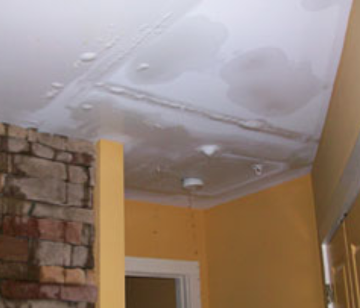 a picture of a ceiling with water damage or bubbling