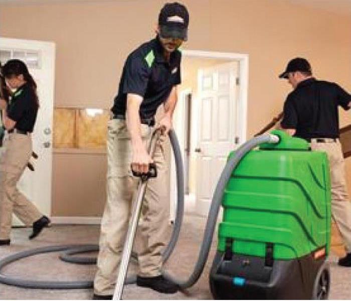 a picture of SERVPRO techs extracting standing water