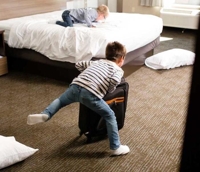 a picture of kids running in a hotel room